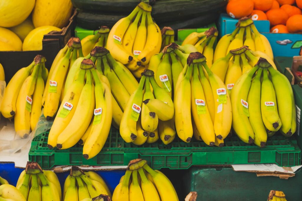 A vibrant display of fresh bananas at a local market stand, perfect for healthy eating.